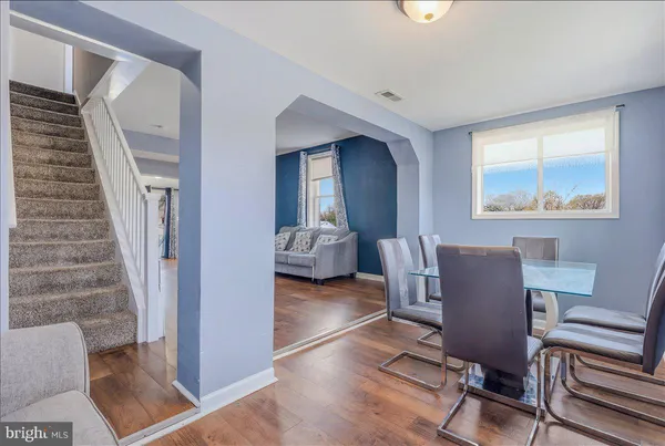 a view of a livingroom with furniture and staircase