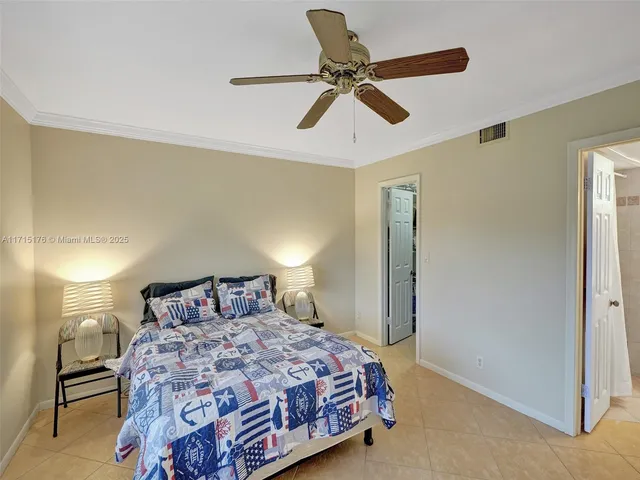 a bedroom with a bed and painting on the wall