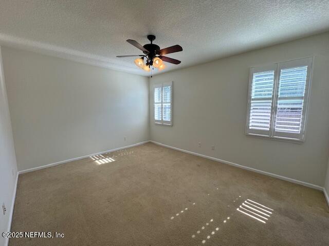 9688 Woodstone Mill Jacksonville, FL 32244 - Photo 13 of 19 an empty room with windows and fan