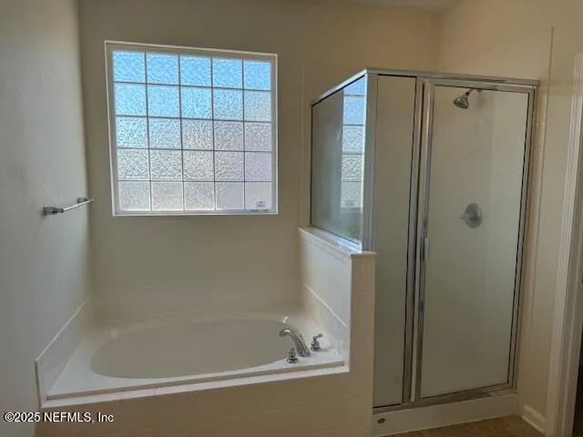 a bathroom with a shower and a bathtub