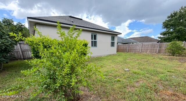 9688 Woodstone Mill Jacksonville, FL 32244 - Photo 19 of 19 a view of a house with a yard