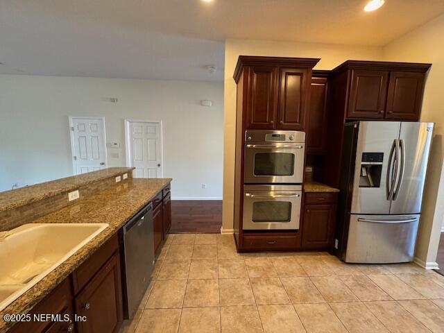 9688 Woodstone Mill Jacksonville, FL 32244 - Photo 7 of 19 a kitchen with granite countertop a refrigerator and a stove