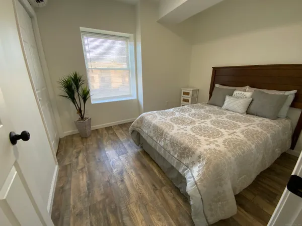 a bed sitting in a bedroom next to a window