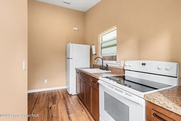a kitchen with a stove and a refrigerator
