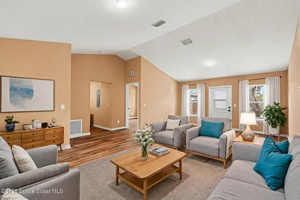 a living room with furniture and a large window