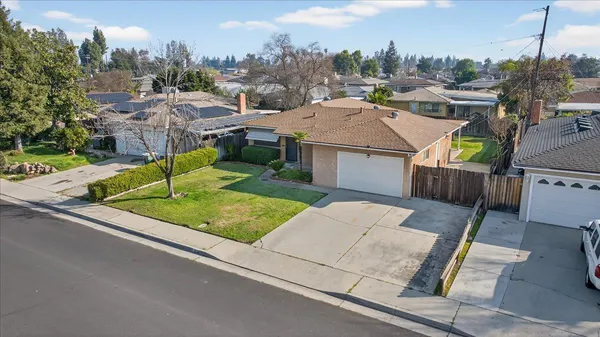 an aerial view of a house with garden space and street view