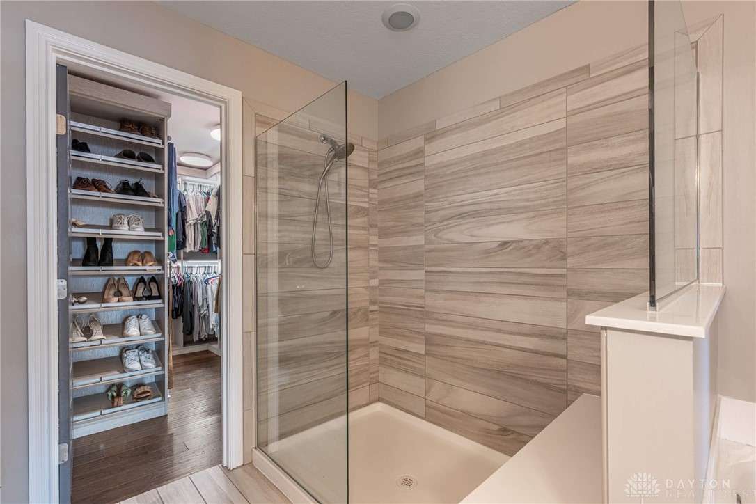 407 Brownstone Row Springboro, OH 45066 - Photo 29 of 54 This modern bathroom features a spacious glass-enclosed shower and a walk-in closet.