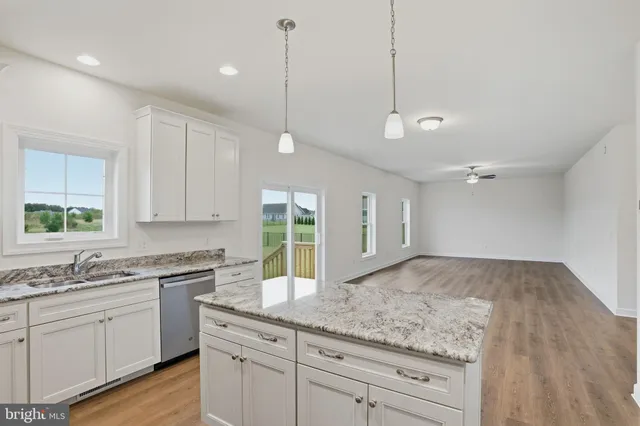 a kitchen with granite countertop kitchen island white cabinets and white appliances