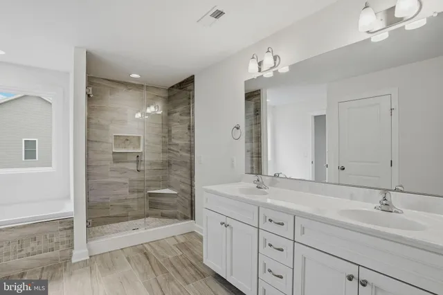 a bathroom with double sink and a mirror