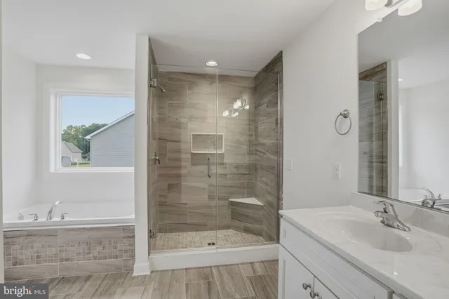 a bathroom with a shower sink and mirror
