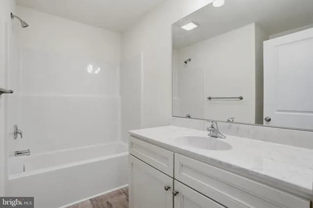 a bathroom with a sink a shower and a bathtub