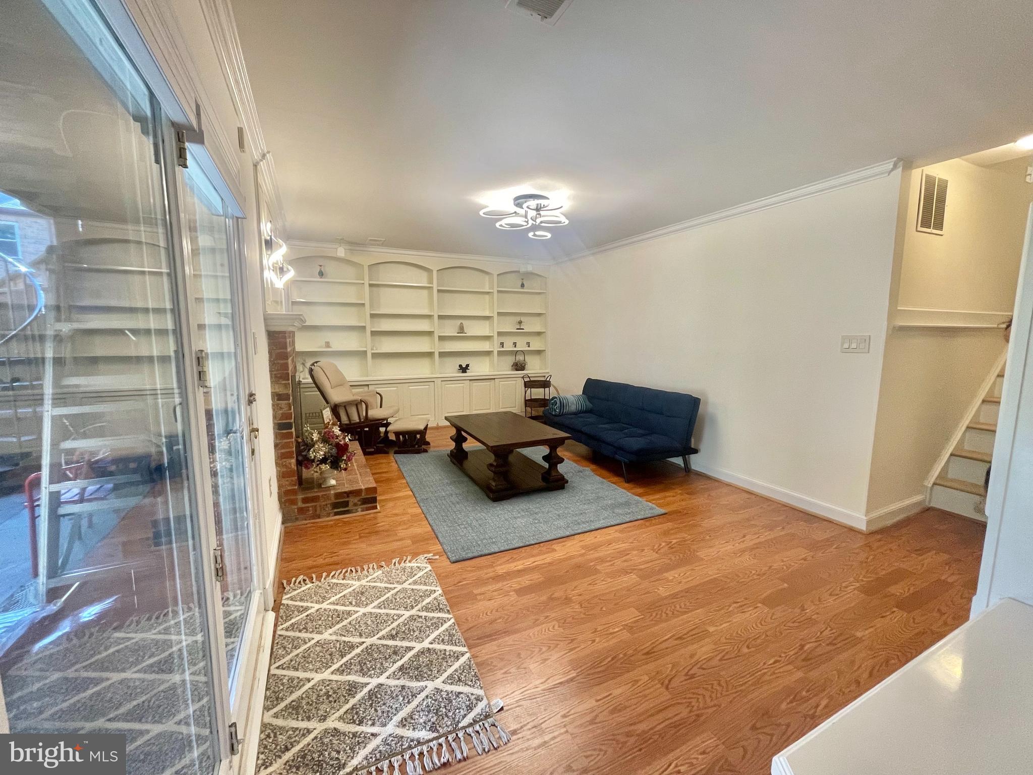 8526 Raglan Road Vienna, VA 22182 - Photo 2 of 12 a view of a livingroom with furniture and a refrigerator