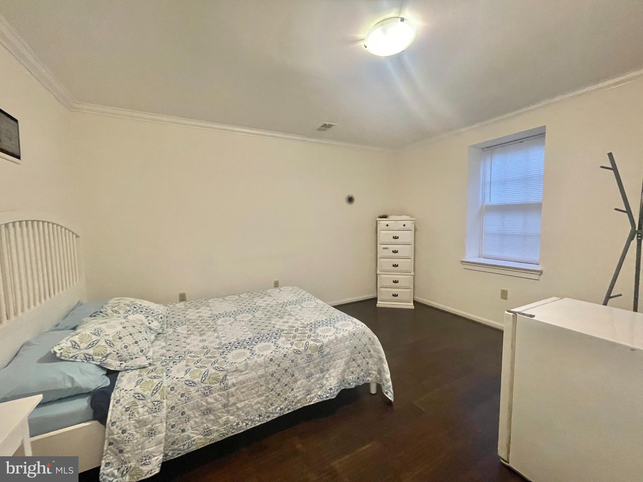 8526 Raglan Road Vienna, VA 22182 - Photo 4 of 12 a bedroom with a bed and a window