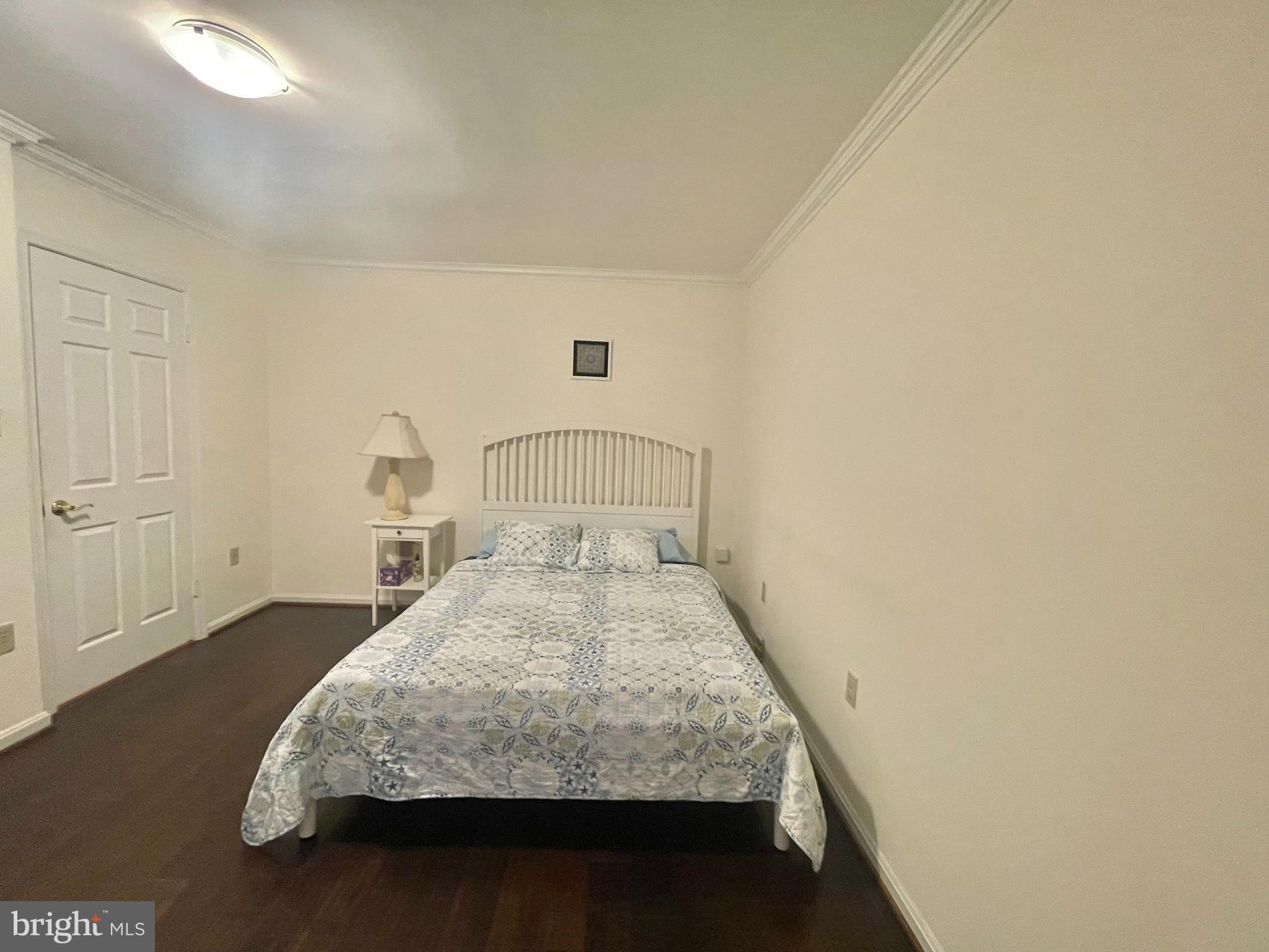 8526 Raglan Road Vienna, VA 22182 - Photo 5 of 12 a bedroom with a bed and a table