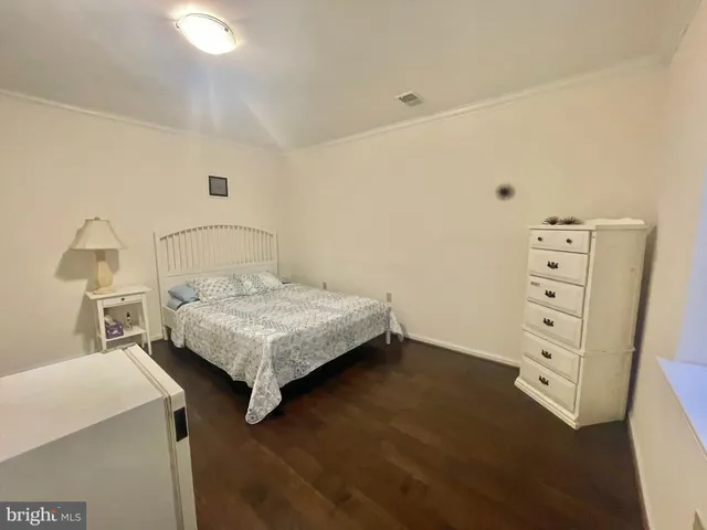 a bedroom with a bed and a night stand