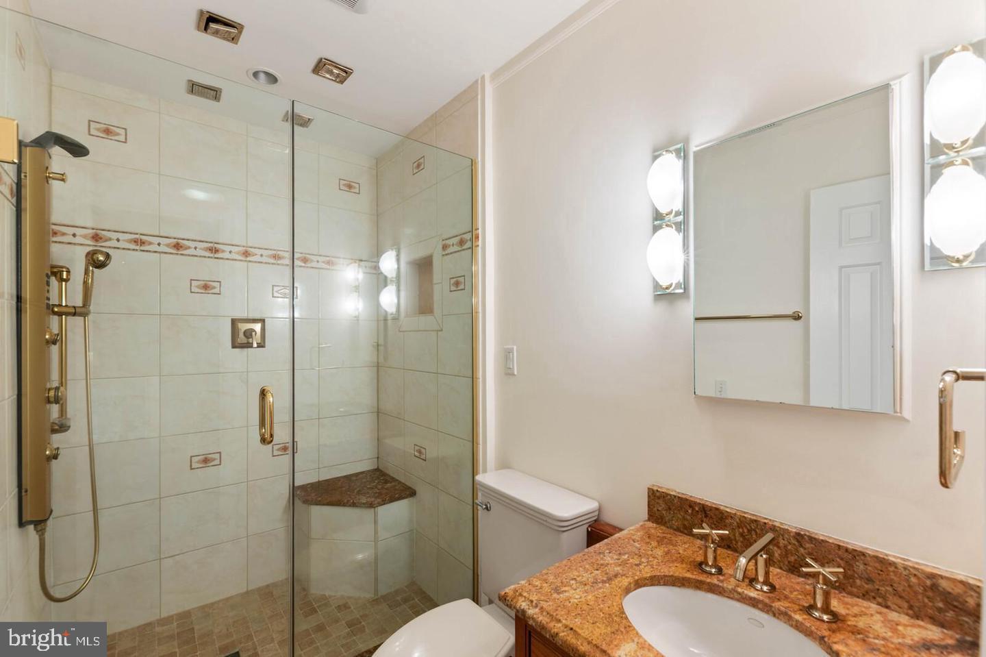 8526 Raglan Road Vienna, VA 22182 - Photo 7 of 12 a bathroom with a shower sink mirror and toilet