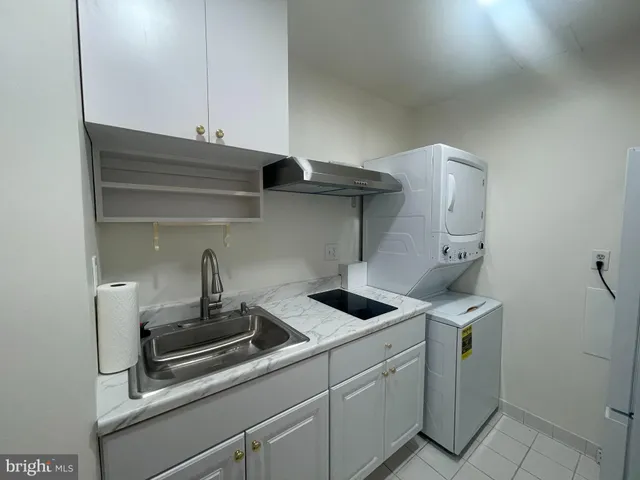 a kitchen with stainless steel appliances a sink and cabinets