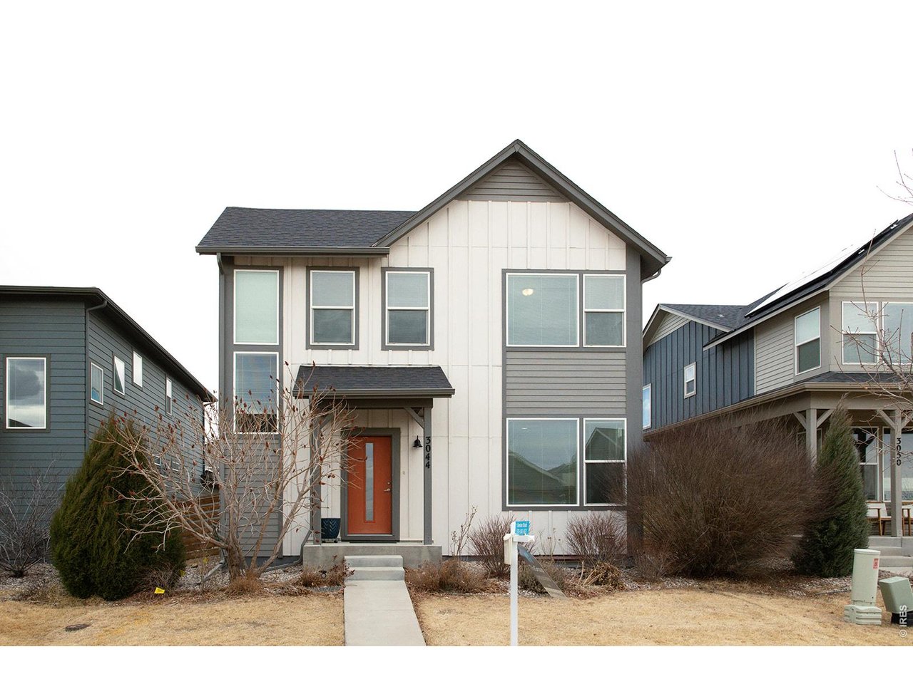 3044 Comet Street Fort Collins, CO 80524 - Photo 2 of 50 The modern exterior makes a memorable first impression, highlighted by a bold orange front door that adds the perfect pop of personality.