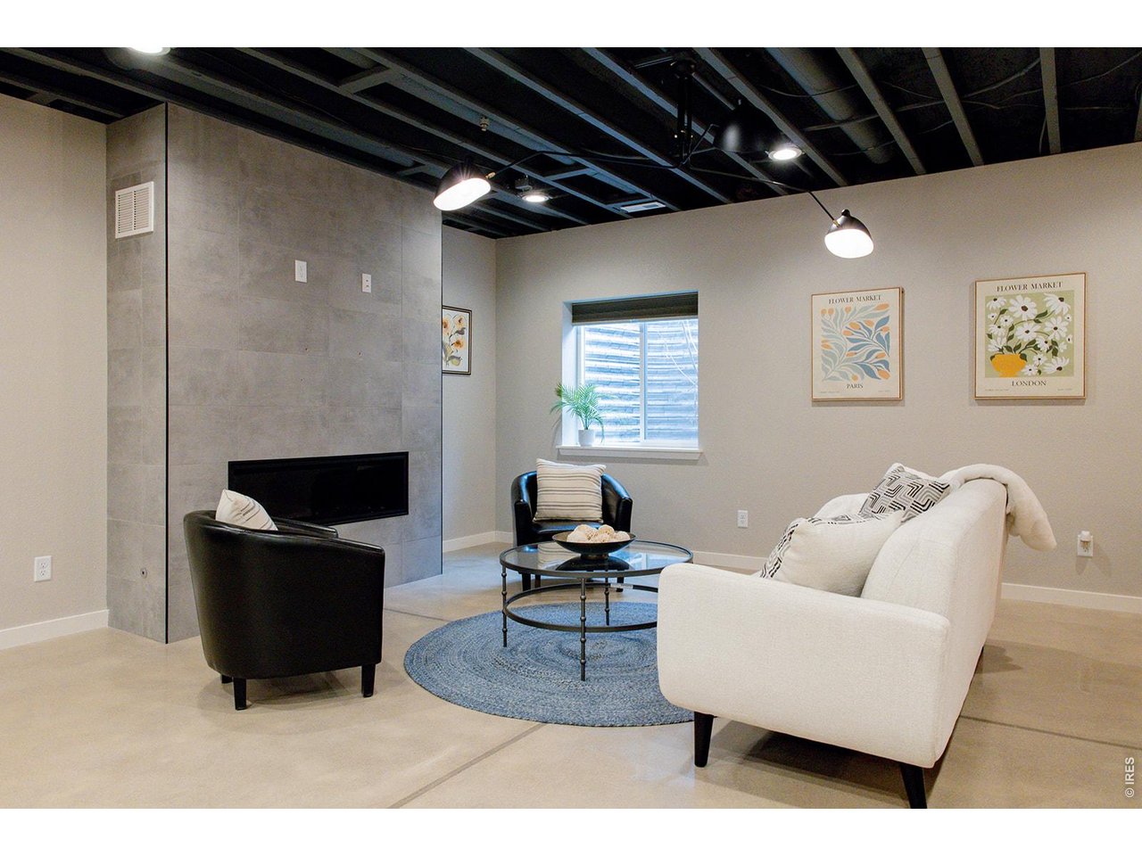 3044 Comet Street Fort Collins, CO 80524 - Photo 21 of 50 Contemporary lighting and electric fireplace enhances the basement's stylish and inviting atmosphere.