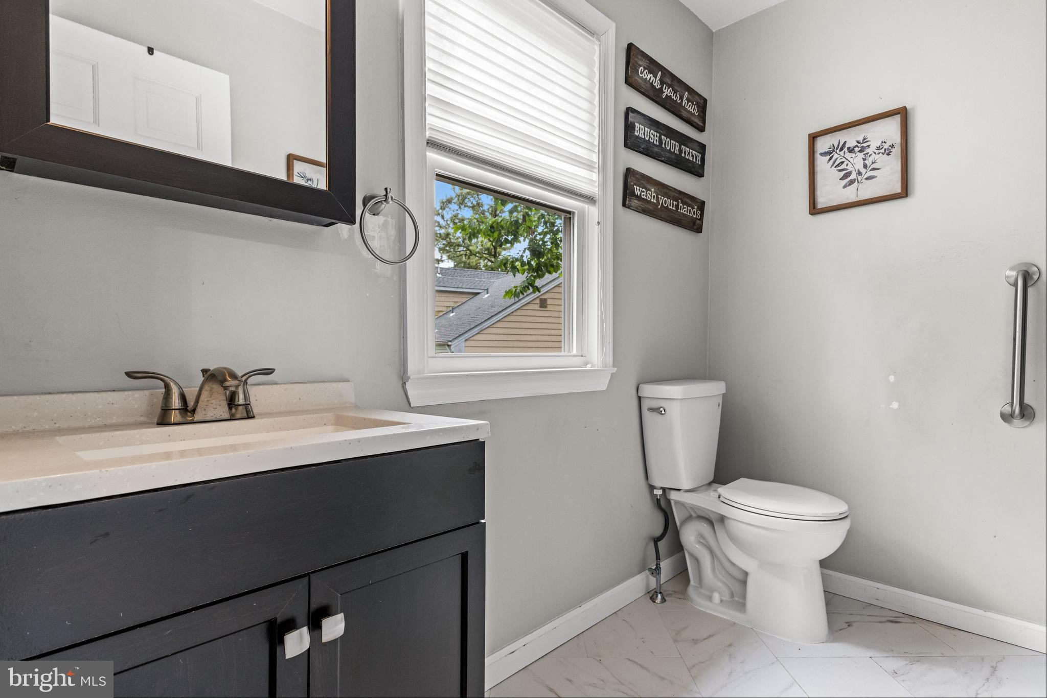 28 Windmill Clementon, NJ 08021 - Photo 19 of 28 a bathroom with a sink a toilet and a window