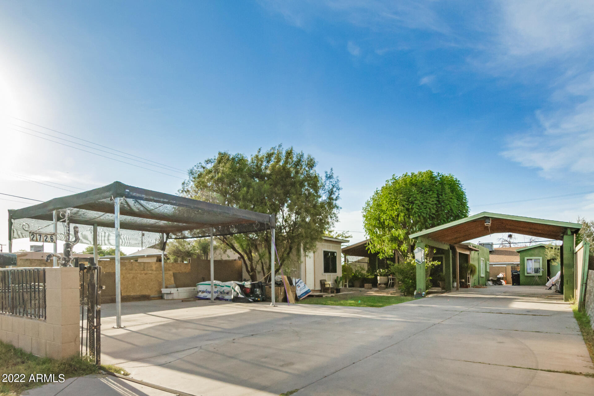 2726 West Taylor Street Phoenix, AZ 85009 - Photo 1 of 26 a patio with a table and chairs under an umbrella