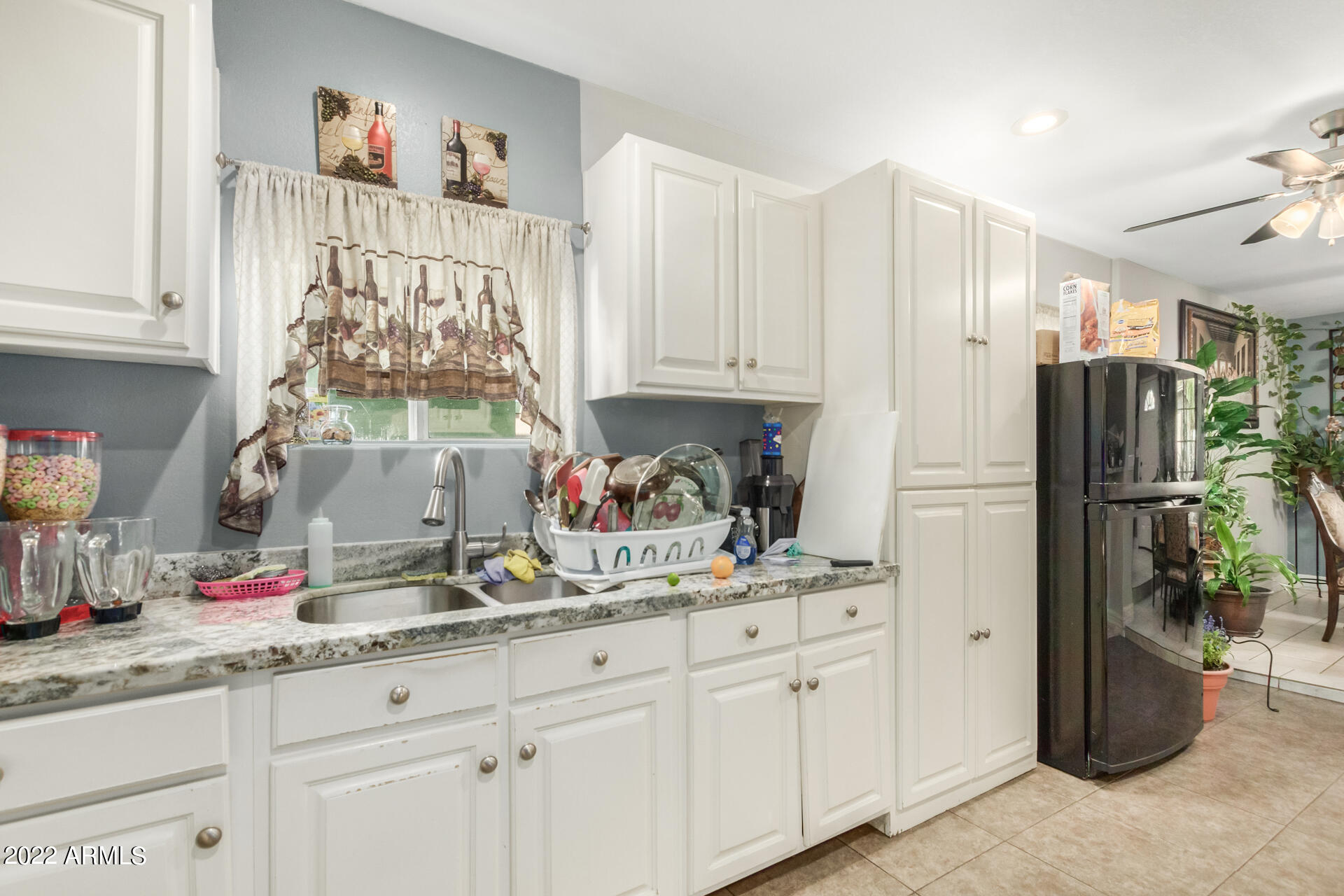 2726 West Taylor Street Phoenix, AZ 85009 - Photo 16 of 26 a kitchen with stainless steel appliances white cabinets and a refrigerator