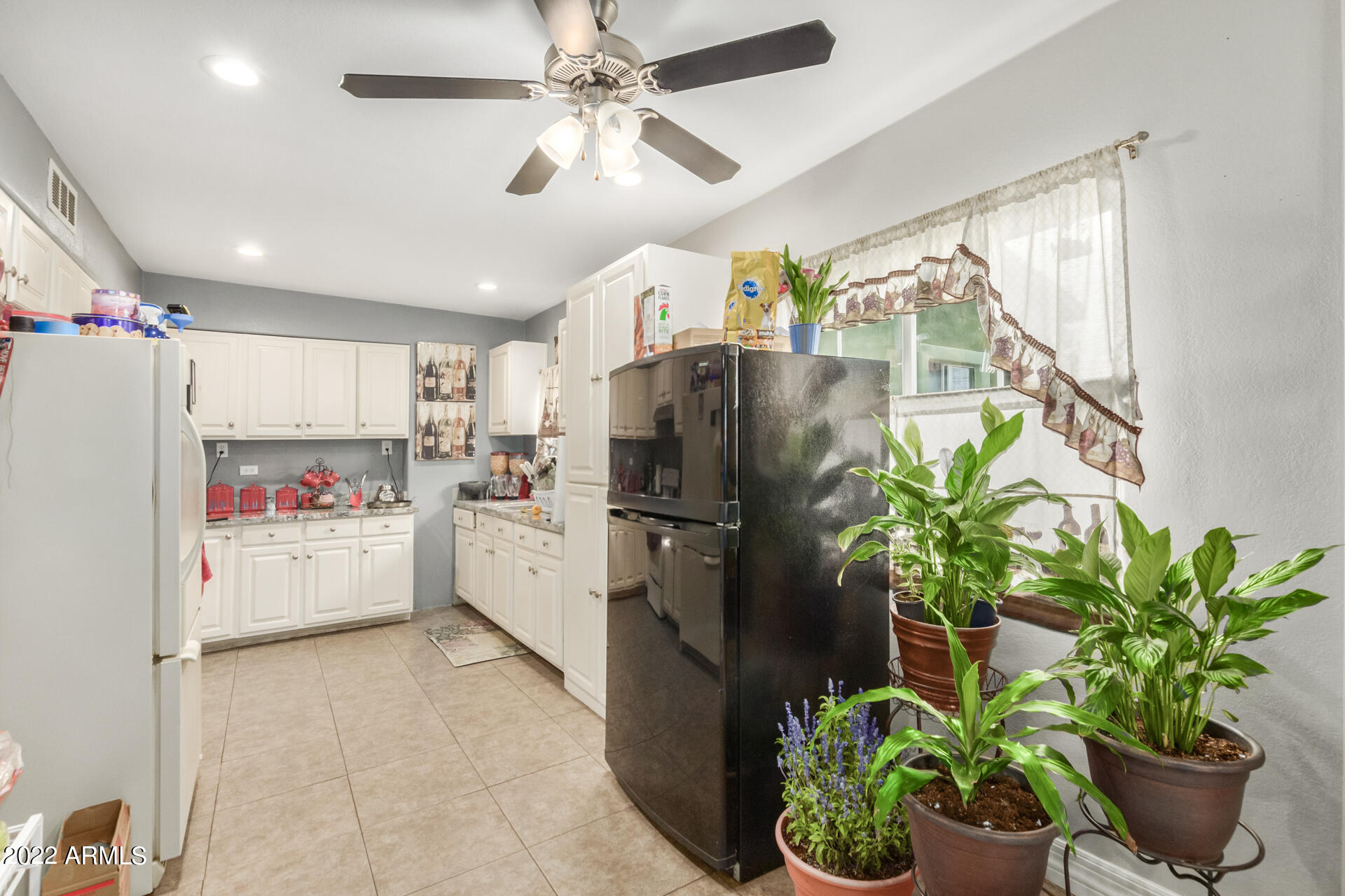 2726 West Taylor Street Phoenix, AZ 85009 - Photo 17 of 26 a kitchen with a refrigerator and a potted plant