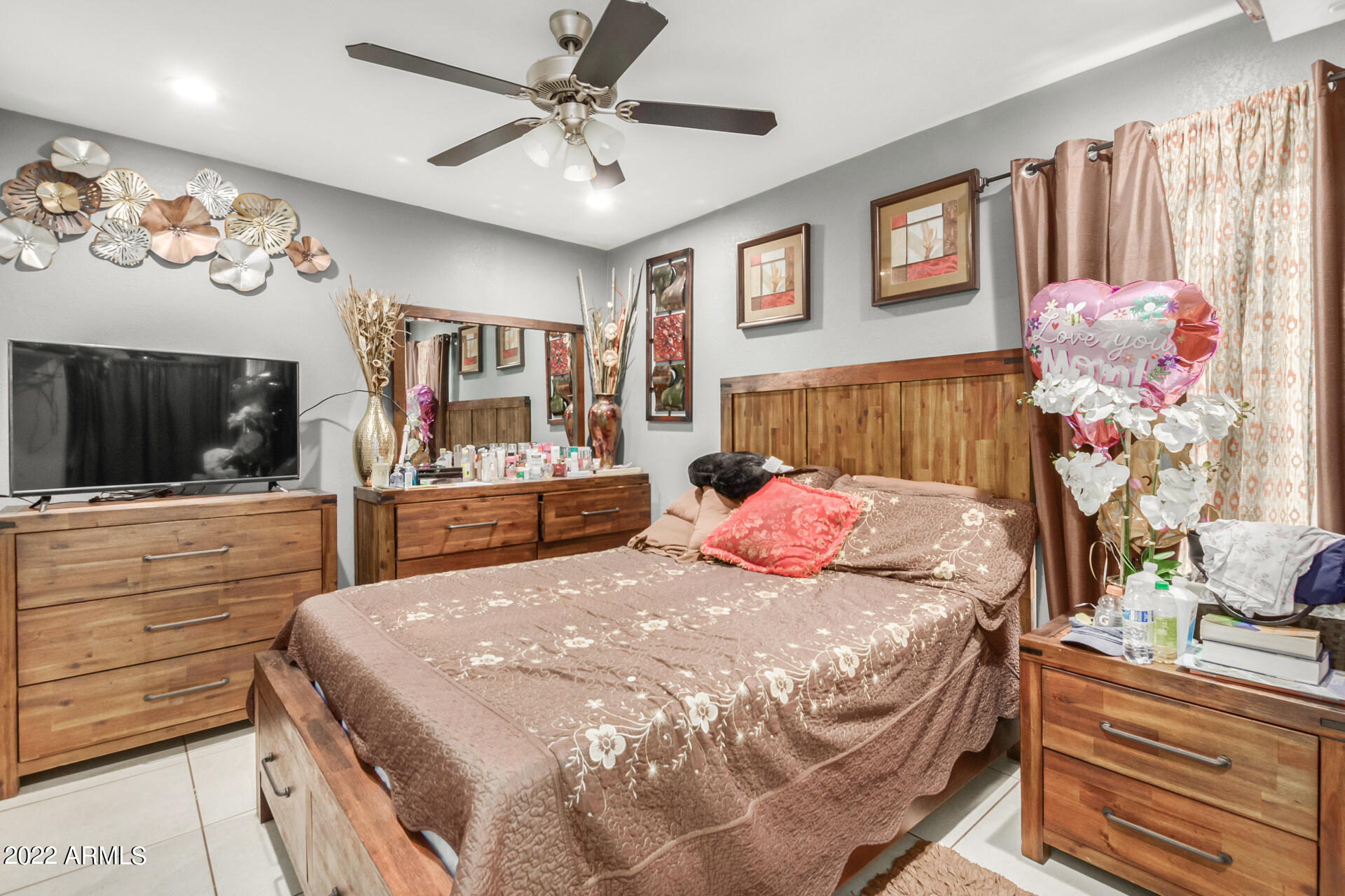 2726 West Taylor Street Phoenix, AZ 85009 - Photo 19 of 26 a bedroom with a bed a dresser and potted plants
