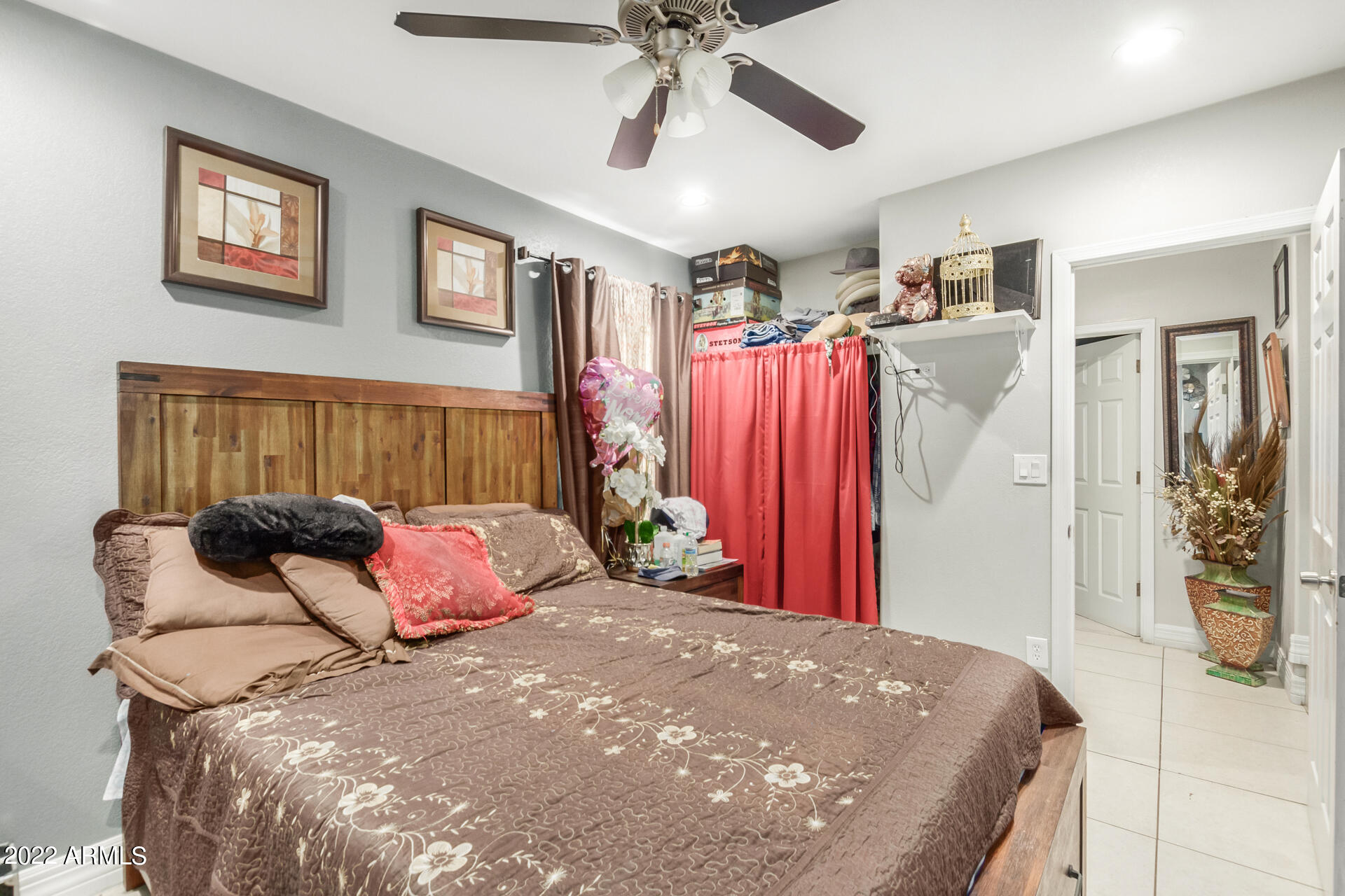 2726 West Taylor Street Phoenix, AZ 85009 - Photo 20 of 26 a bedroom with a large bed and a chandelier