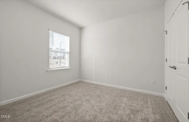 a view of an empty room with windows