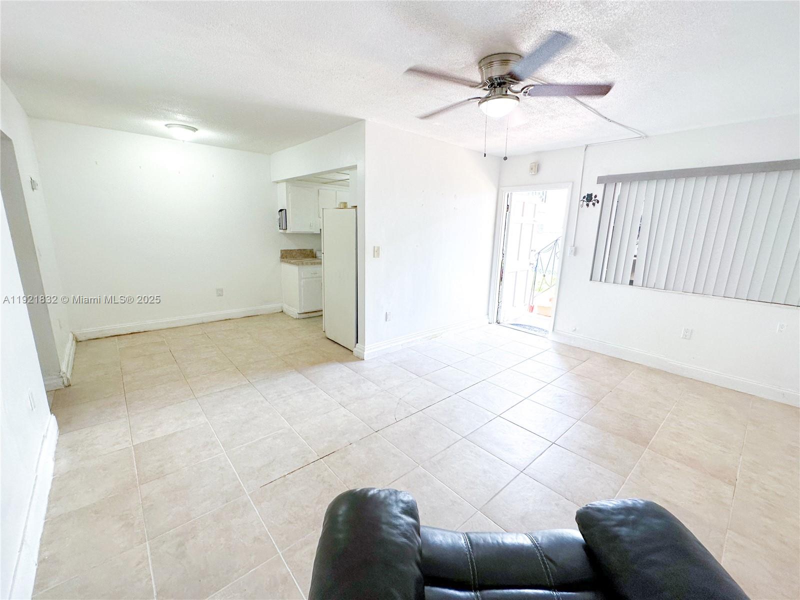 12275 Northeast 19th Avenue, Unit 11 North Miami, FL 33181 - Photo 2 of 13 a view of livingroom with furniture and chandelier fan