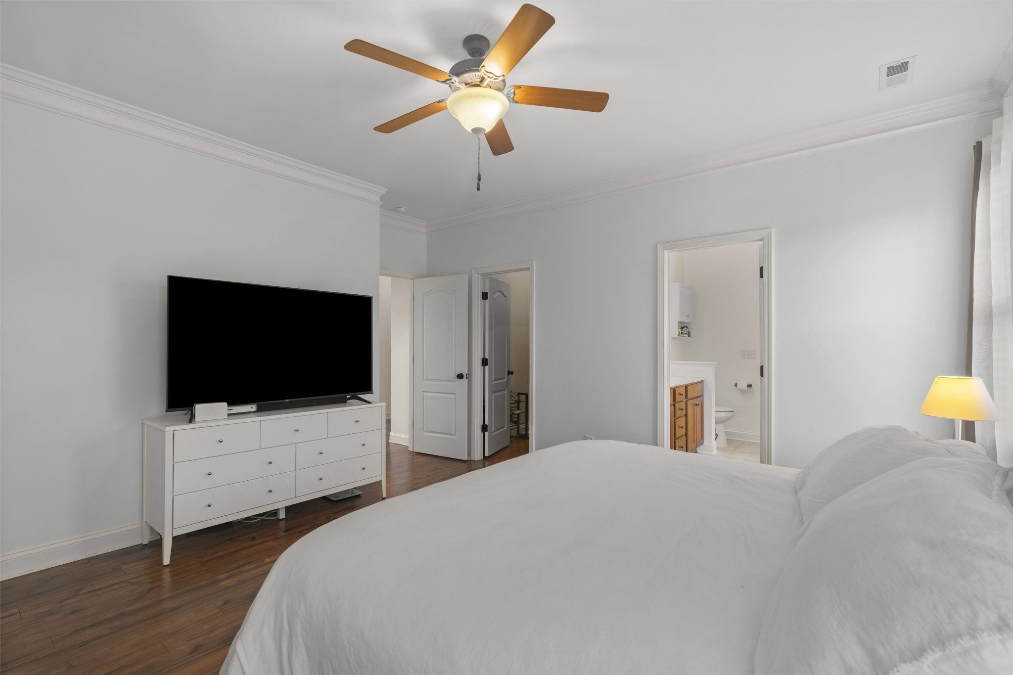 139 Torchie Drive Selma, NC 27576 - Photo 20 of 49 a bedroom with a bed tv and a chandelier