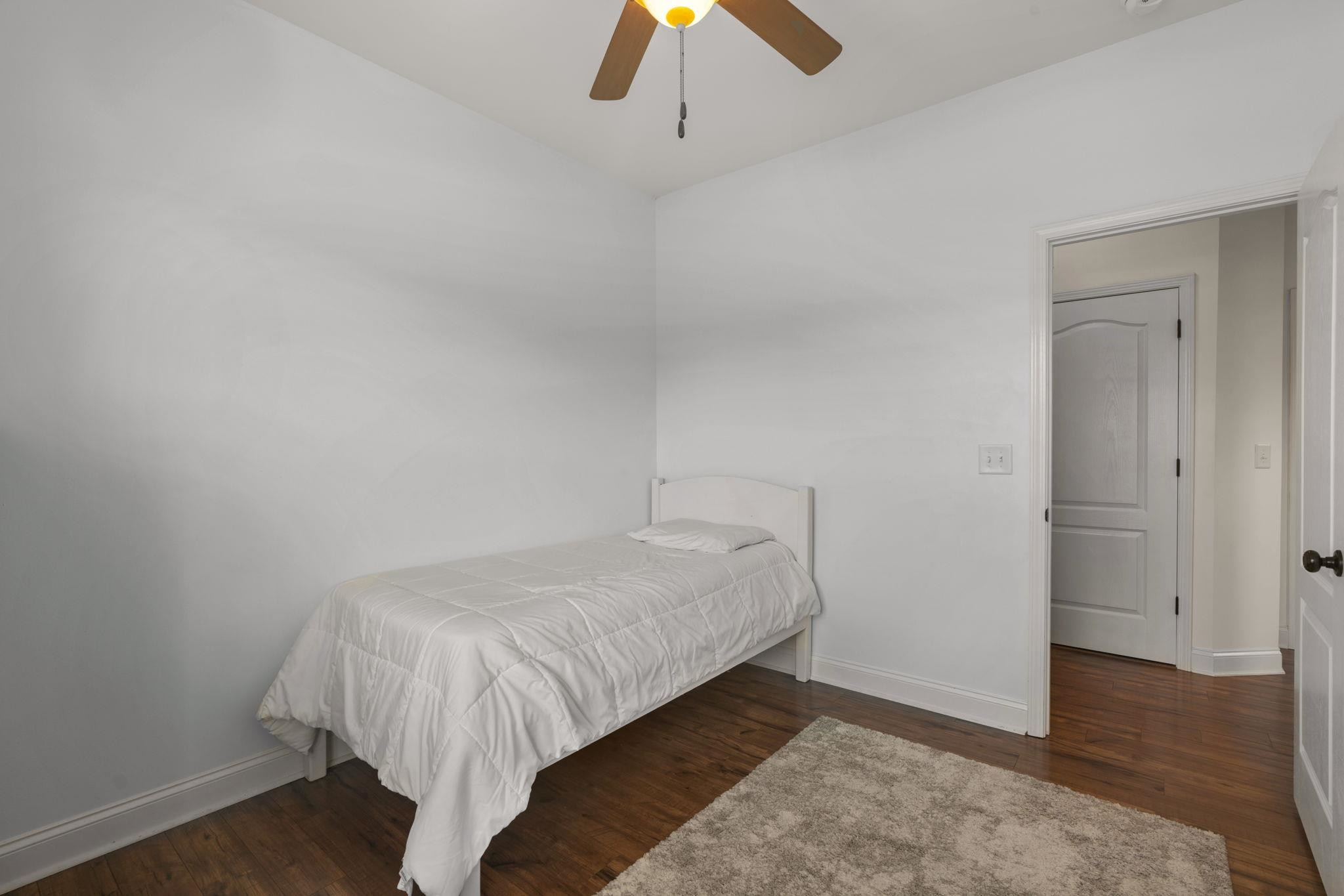 139 Torchie Drive Selma, NC 27576 - Photo 30 of 49 a bed sitting in a bedroom next to a lamp