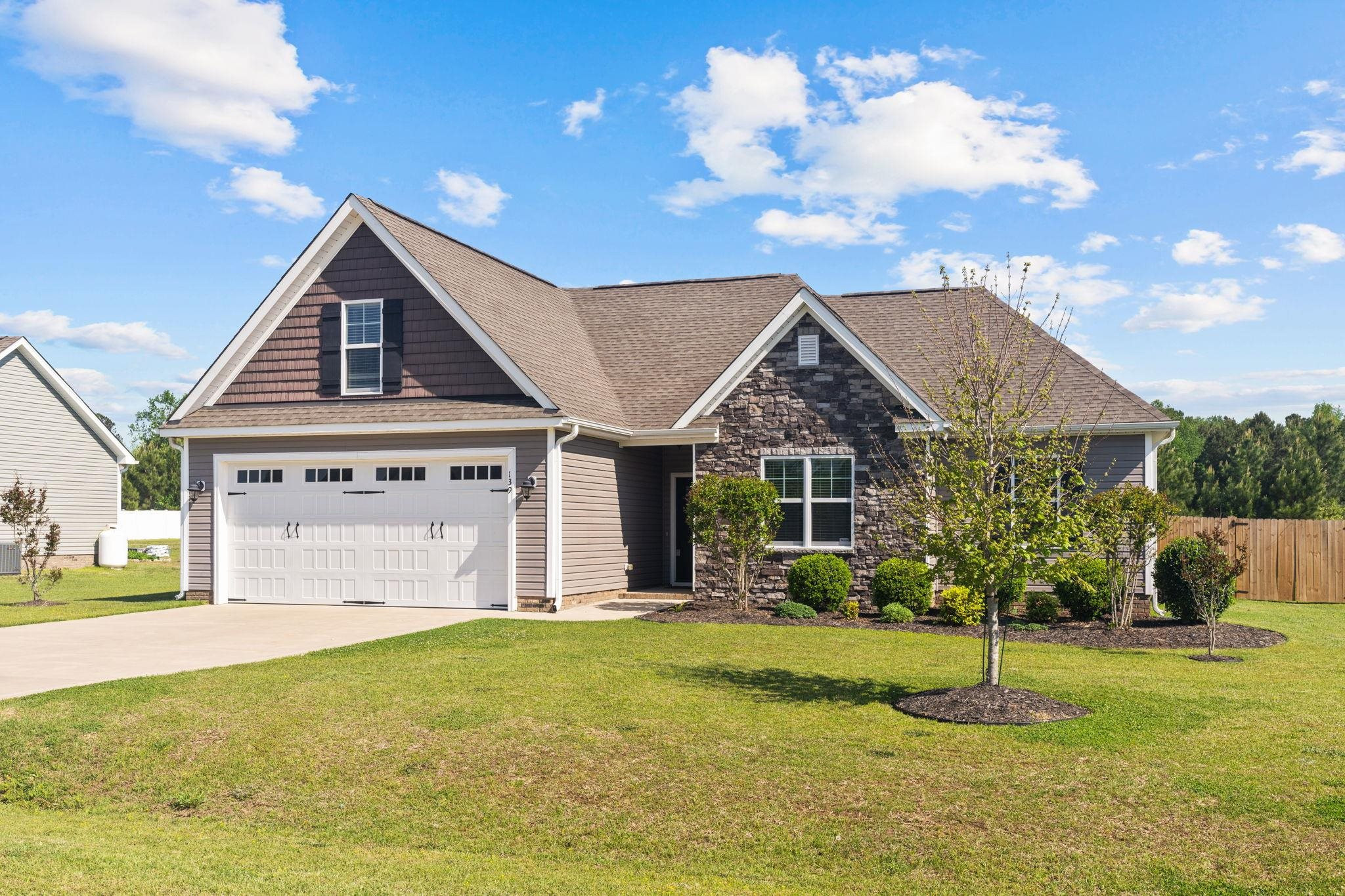 139 Torchie Drive Selma, NC 27576 - Photo 3 of 49 a front view of a house with a yard