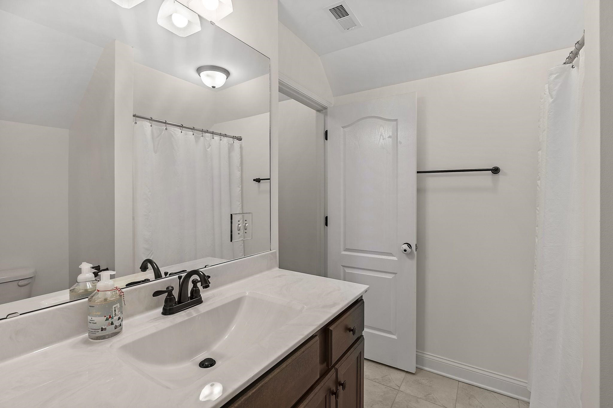 139 Torchie Drive Selma, NC 27576 - Photo 34 of 49 a bathroom with a sink and a mirror