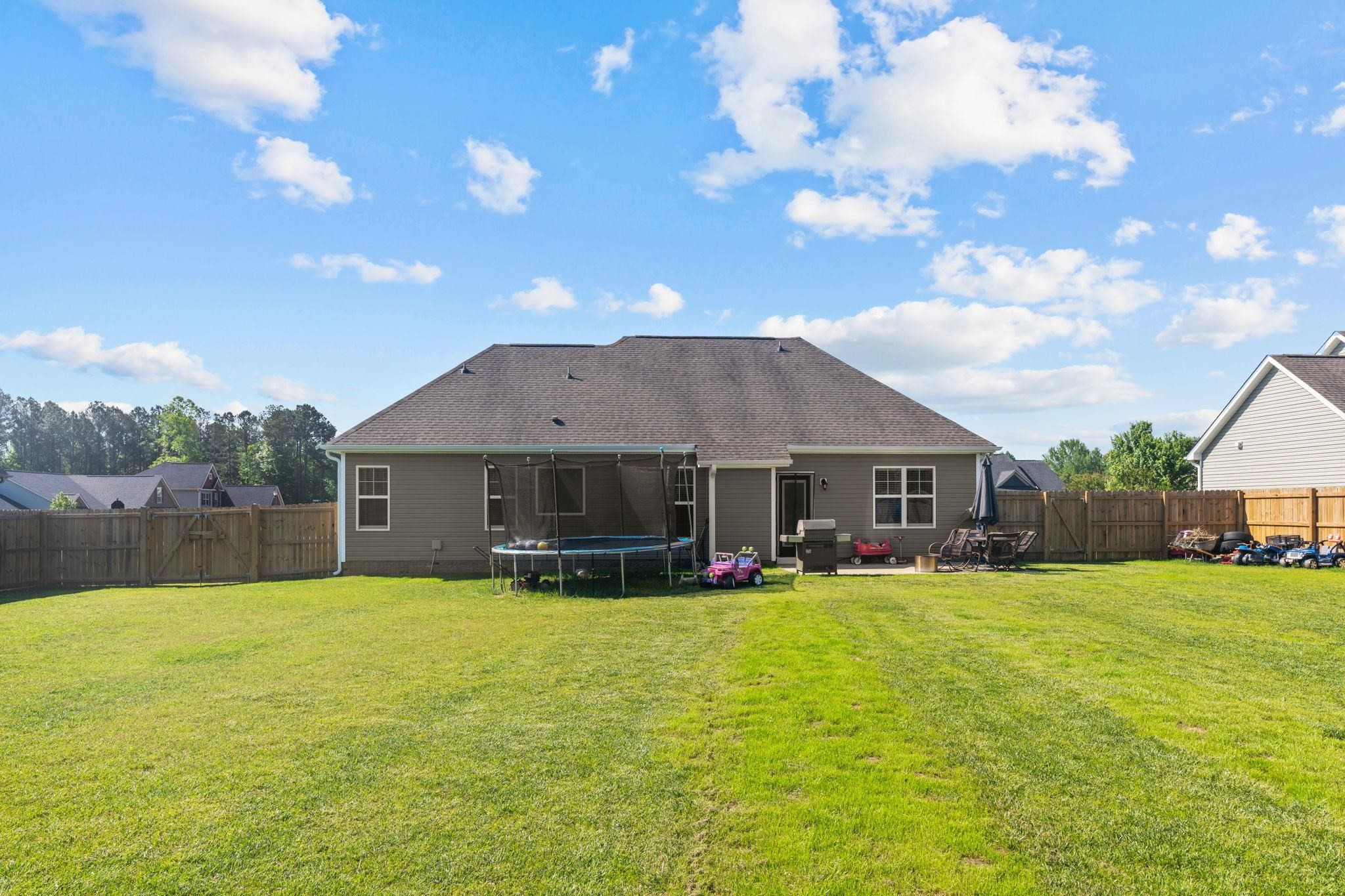 139 Torchie Drive Selma, NC 27576 - Photo 39 of 49 a view of a house with a yard and sitting area
