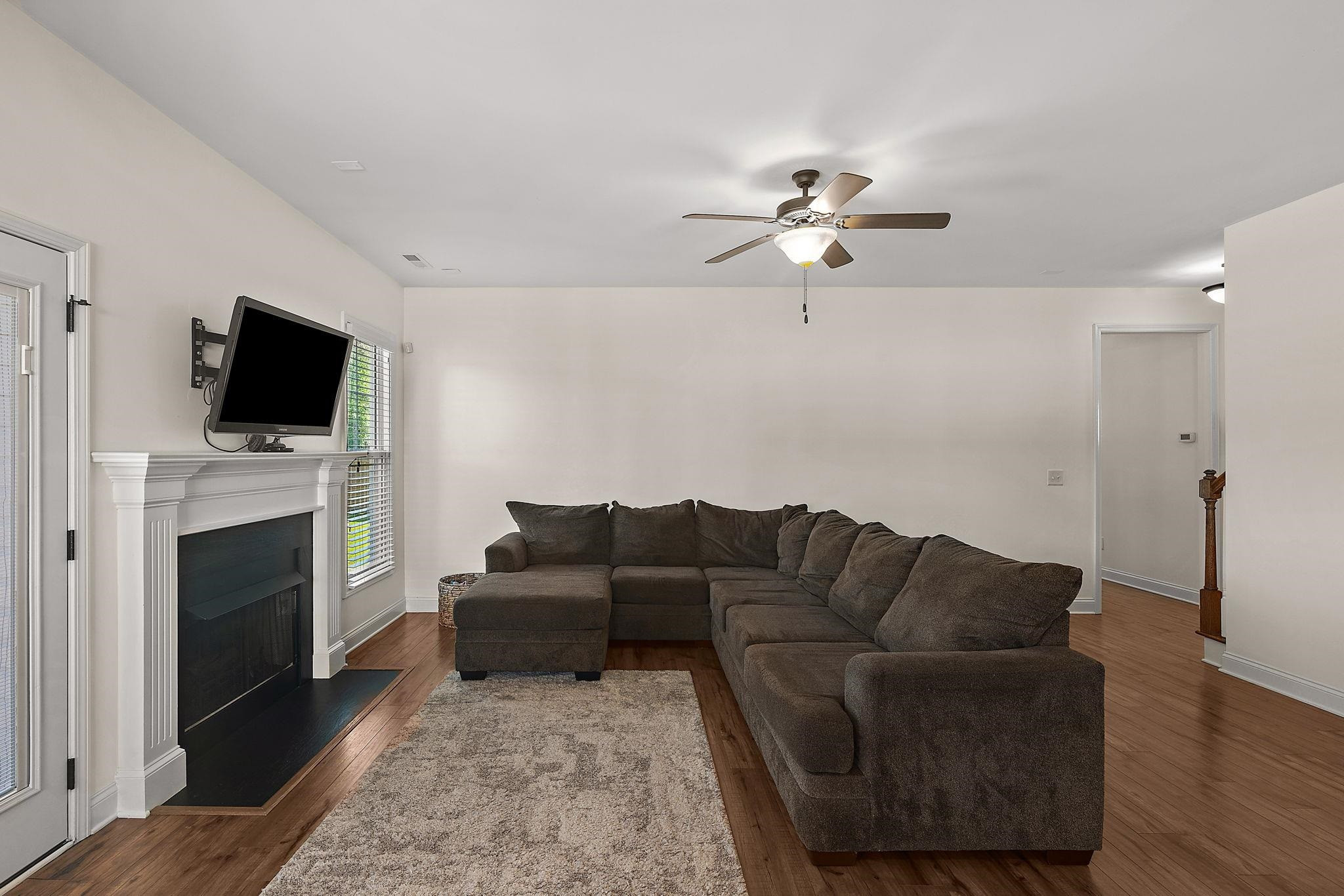 139 Torchie Drive Selma, NC 27576 - Photo 6 of 49 a living room with furniture a fireplace and a flat screen tv