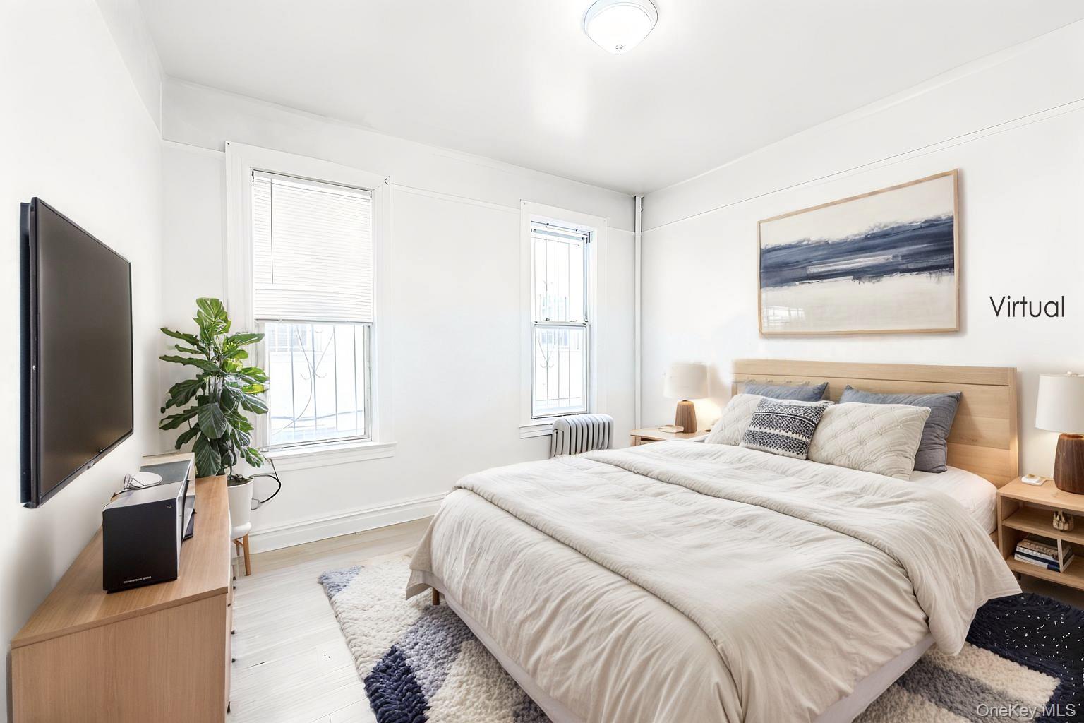 31-39 84th Street Queens, NY 11370 - Photo 18 of 29 a bedroom with a bed and a potted plant