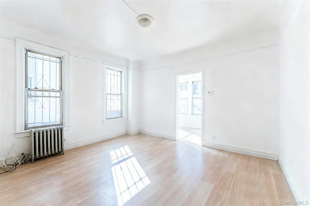 an empty room with a window and closet