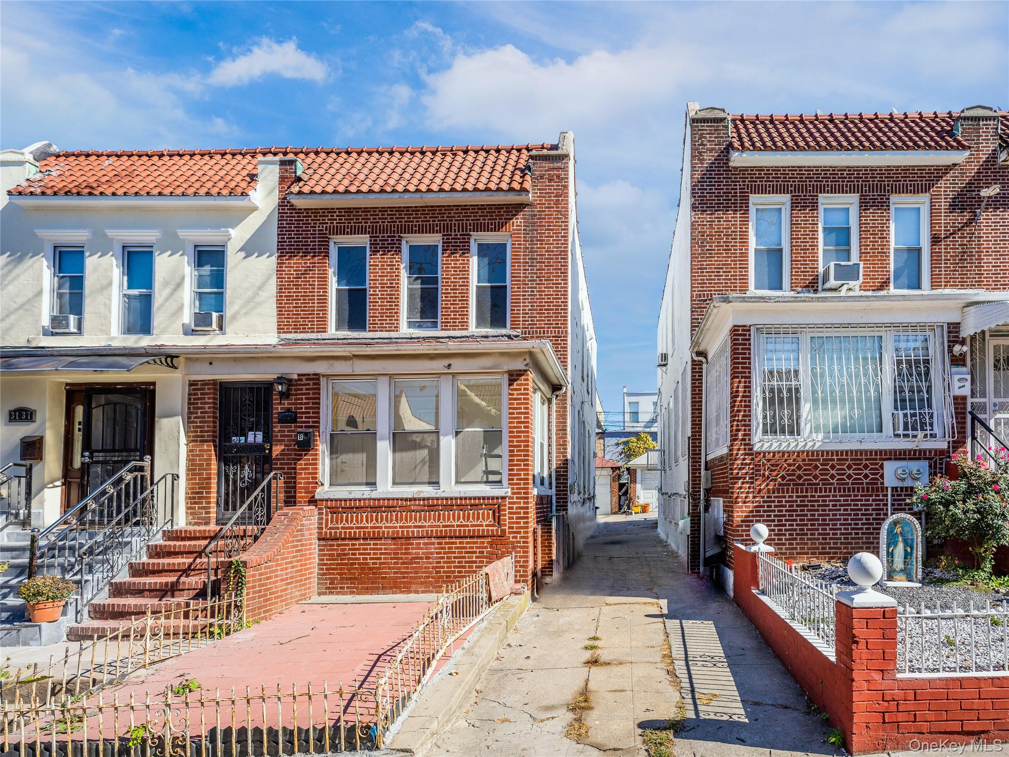 31-39 84th Street Queens, NY 11370 - Photo 2 of 29 a front view of a building with glass windows