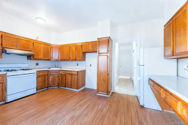 a kitchen with a window wooden floors and stainless steel appliances