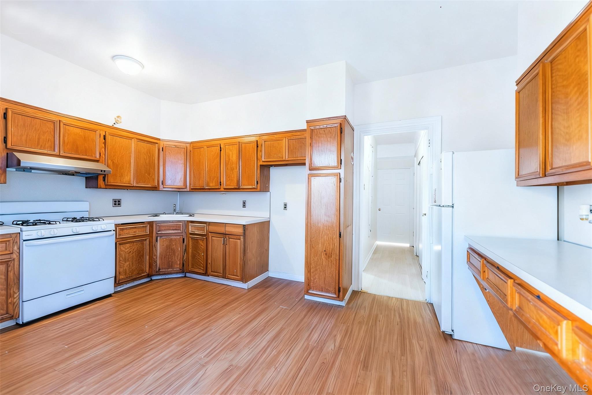 31-39 84th Street Queens, NY 11370 - Photo 4 of 29 a kitchen with a wooden floor and a kitchen