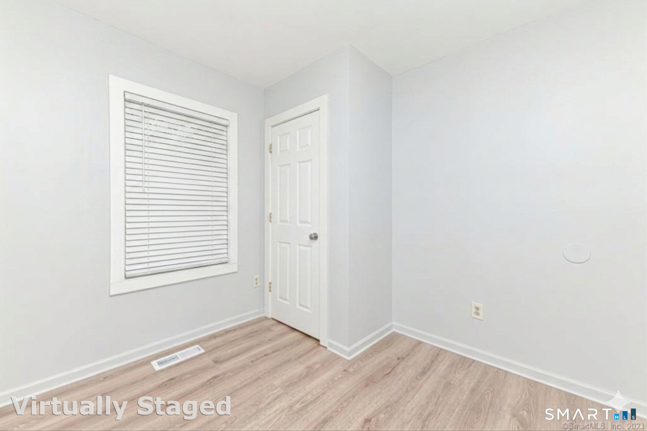 37 Manhan Street Waterbury, CT 06710 - Photo 10 of 19 a view of an empty room with wooden floor and a window