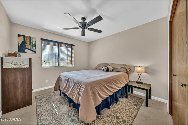 a bedroom with a bed and a table in it