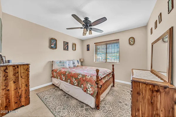 a bathroom with a granite countertop double vanity sink and a mirror