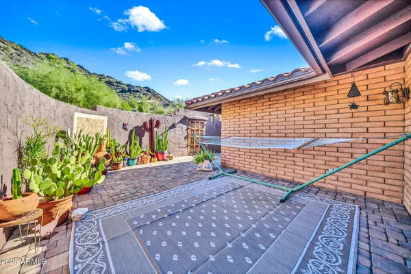 a en suite bathroom with a granite countertop sink and a mirror