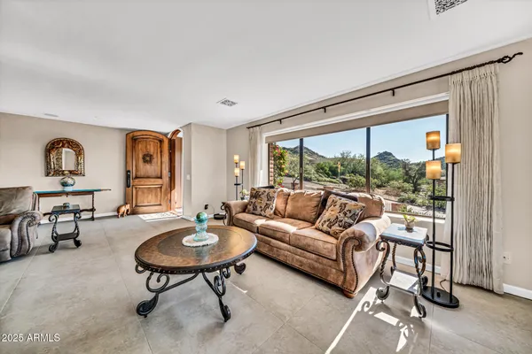 a front view of a house with a yard and potted plants