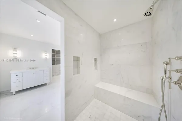 a bathroom with a bathtub and a shower