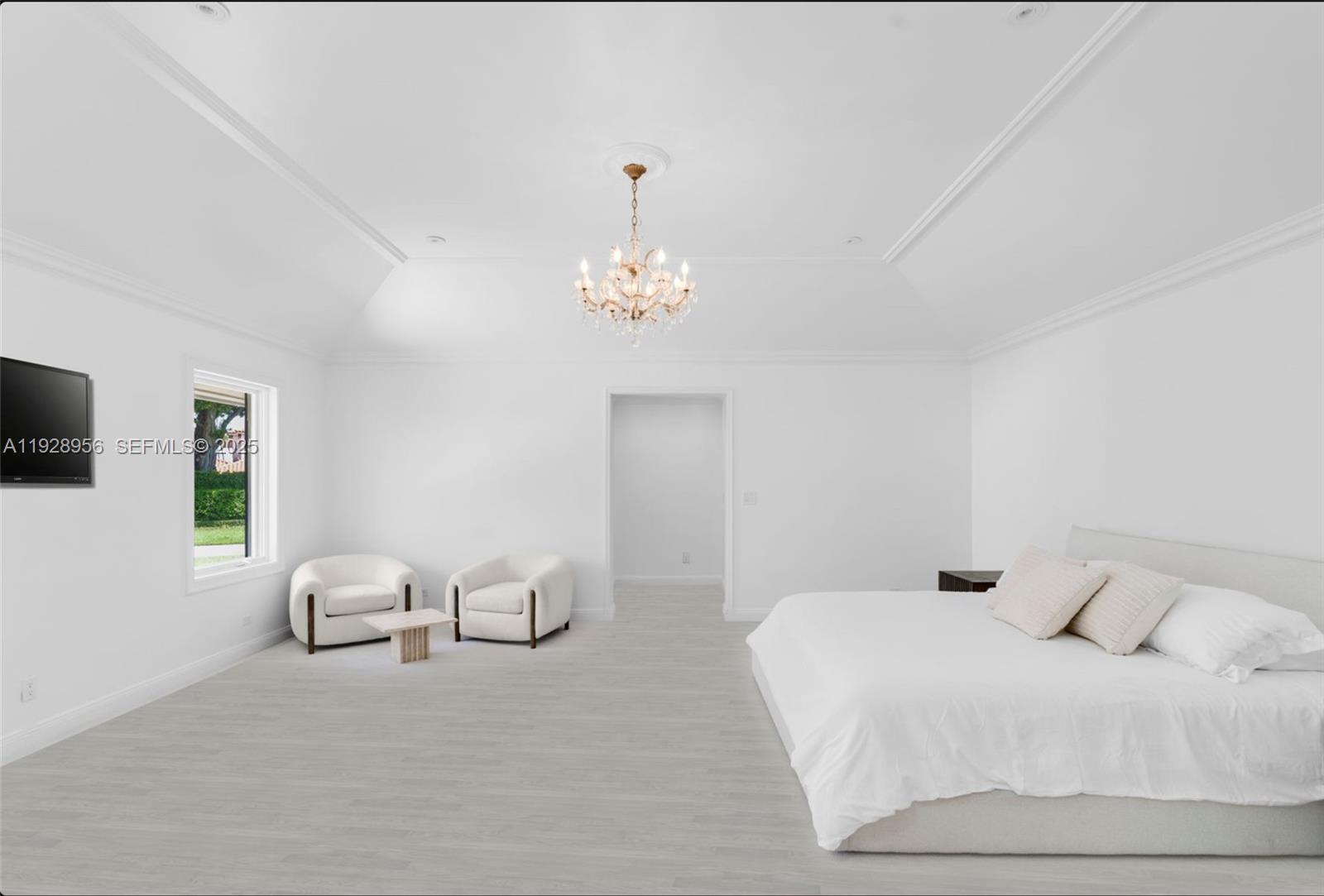 55 Lagorce Circle Miami Beach, FL 33141 - Photo 8 of 13 a bedroom with a bed and a chandelier