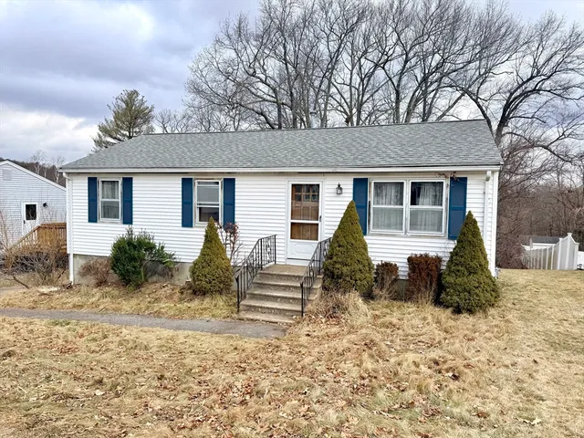 front view of house with a bench in front of house